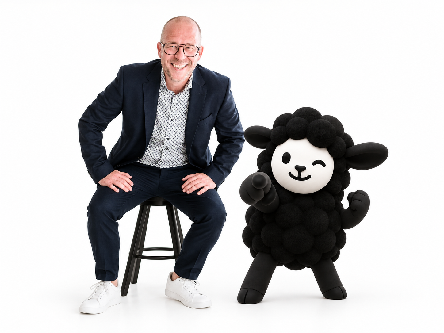 Stefan Avivson sitting on a stool next to the RSN black sheep